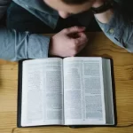 web3-man-reading-bible-book-alexander-michl-unsplash-cc0.webp